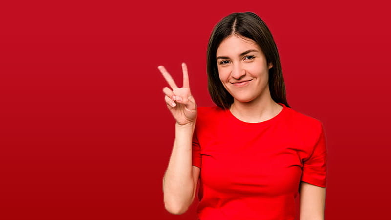 Women holding up 2 fingers with red background