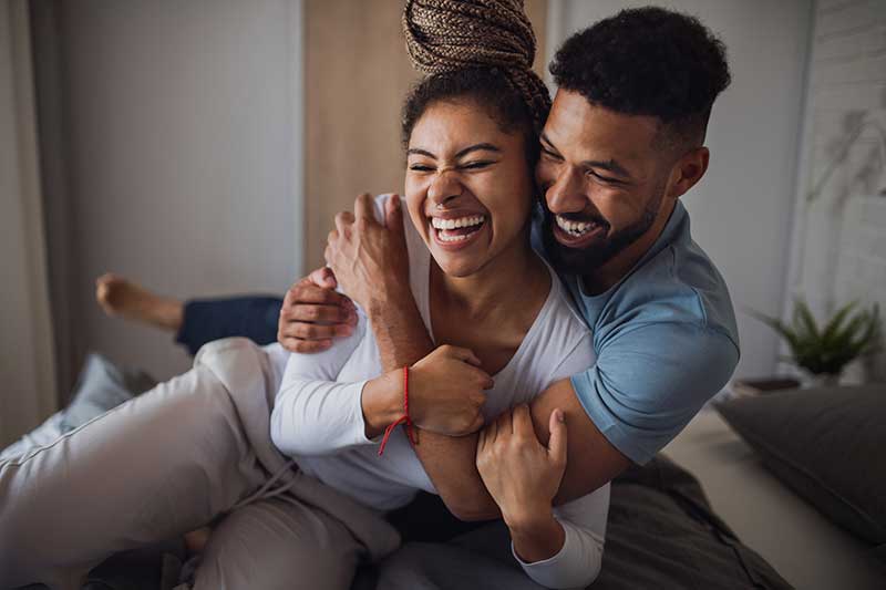 happy couple laughs and hugs indoors happy couple laughs and hugs indoors