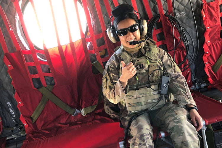 Class of Survivors member Jia Wu in her military fatigues on a plane
