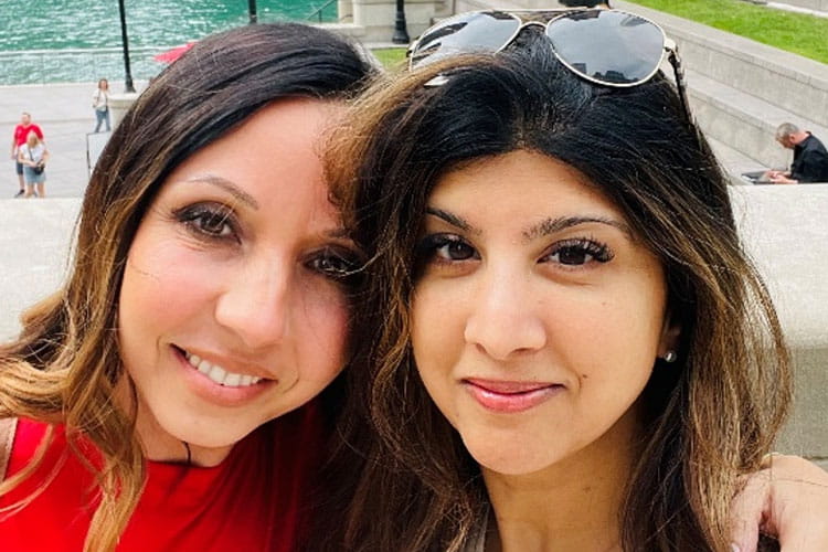 Class of Survivors member Priti Langer and friend taking a selfie at a park
