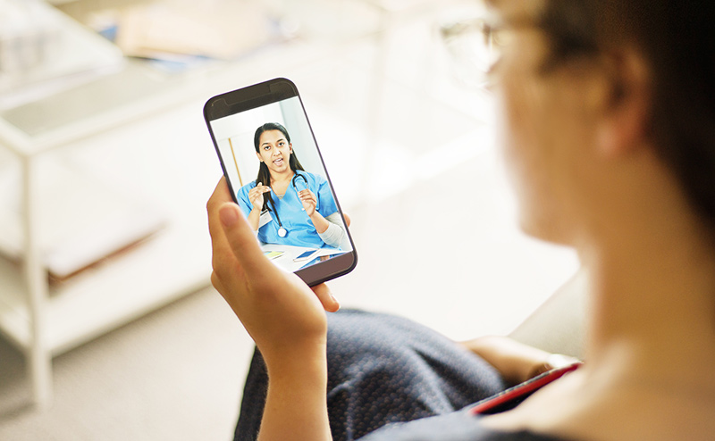 woman has virtual doctor's appointment on phone