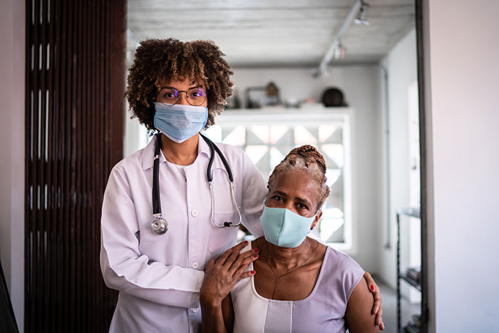 Women doctor and [patient wearing masks