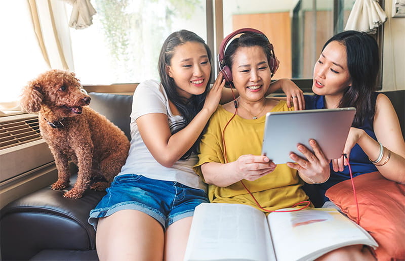 Asian mom sitting with daughters