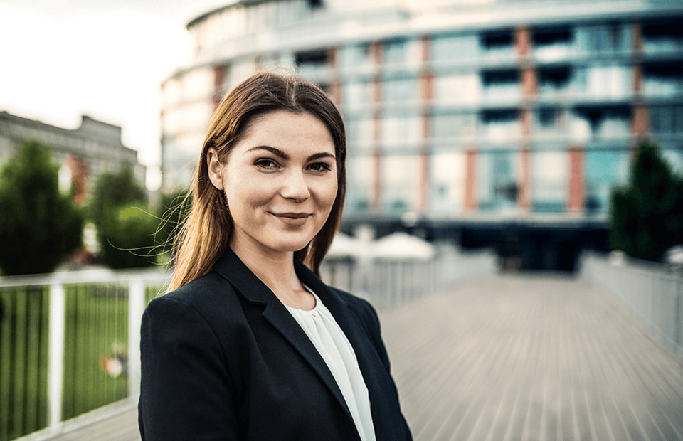 young businesswoman standing in front of a building