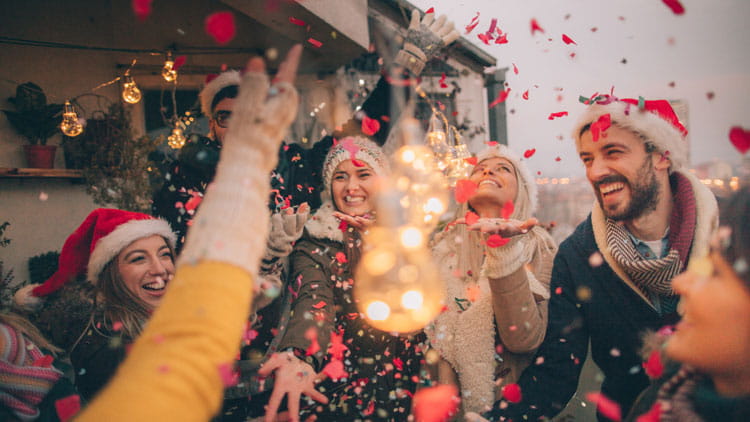 Group of friends celebrating the holidays by throwing a party.