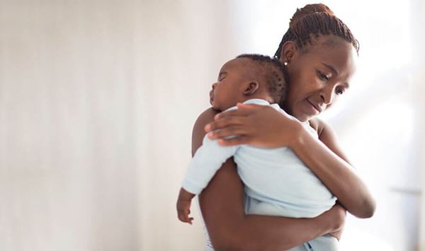 mother holding sleeping infant