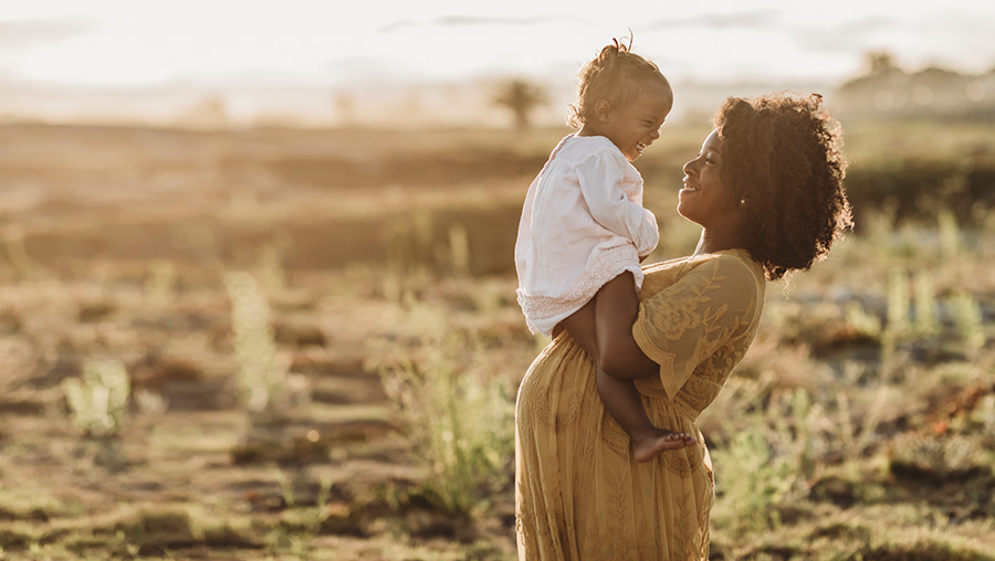 p[regnant mother and child in sunset