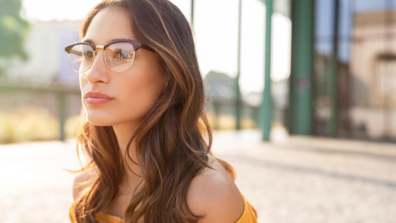 Women outside wearing glasses thinking