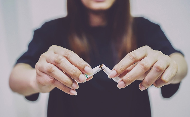 Women learning to smoke cigarettes