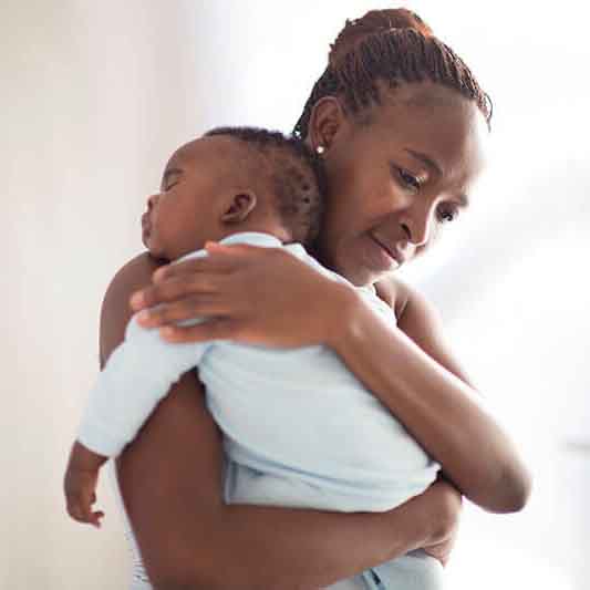 mother holding sleeping infant