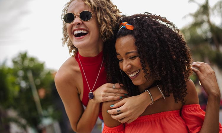 Two your women laughing outside