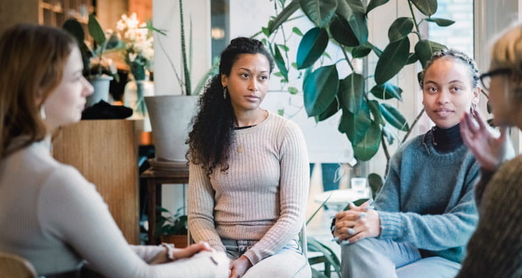 Woman sharing her experiences during a group therapy session.