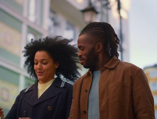 a couple walking down a city street