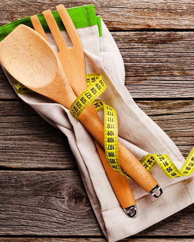 wooden cooking utensils wrap with a body tape measure