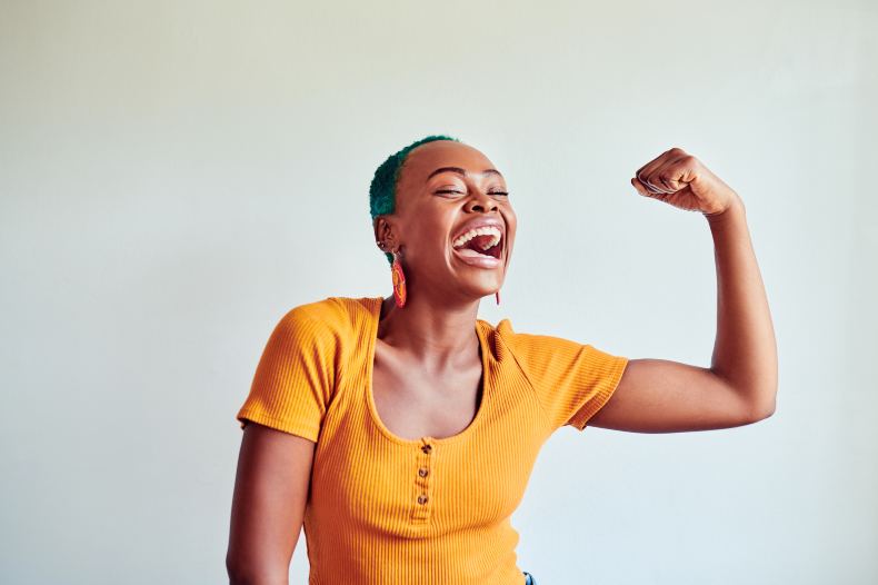 African American woman flexing arm muscle