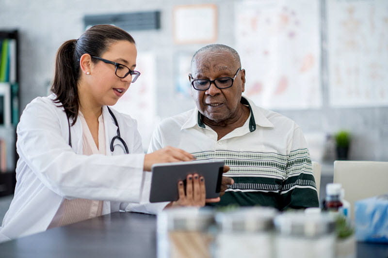 hombre mirando una mesa con un médico