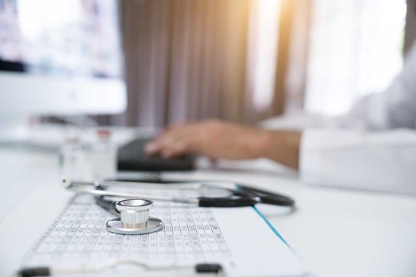 Doctor using a mouse on a computer