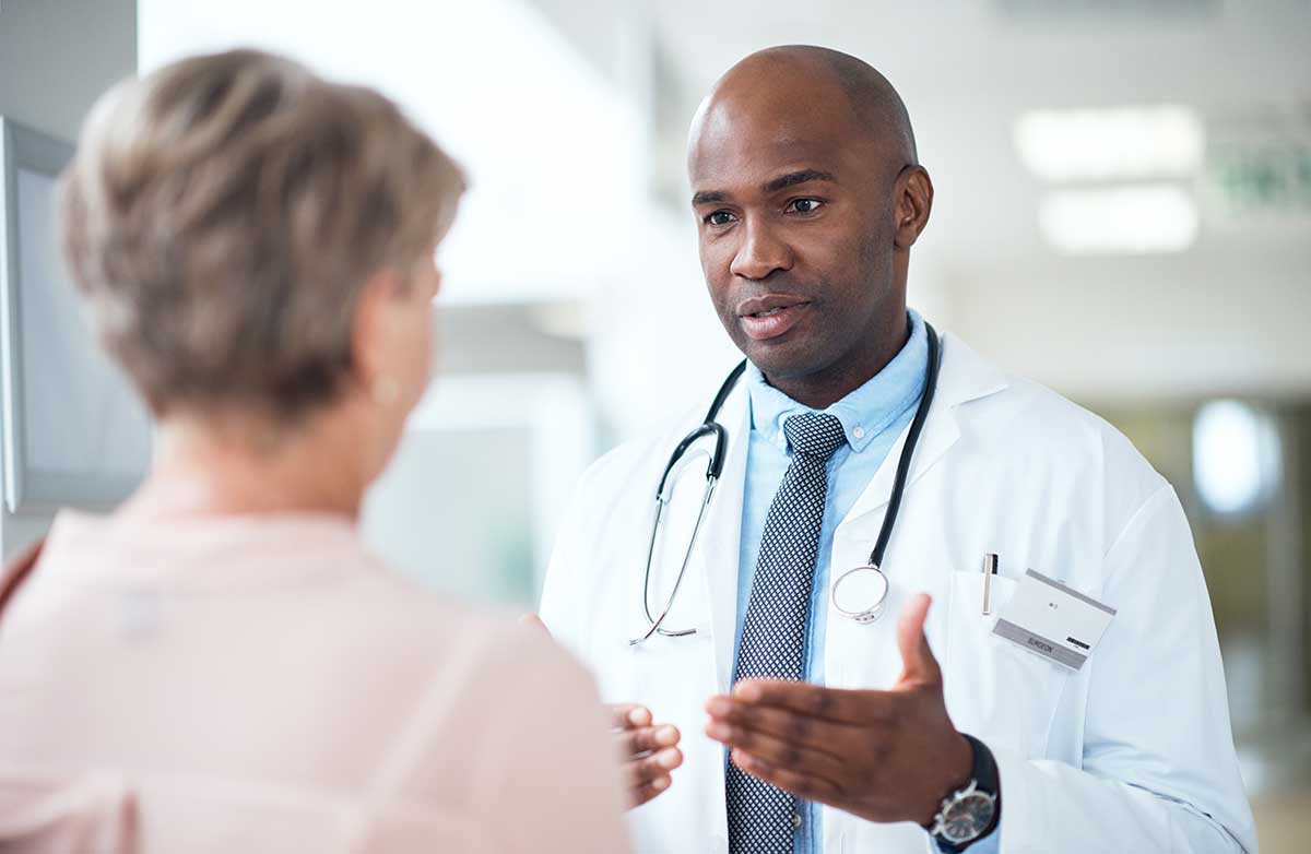 african american doctor speaking with female patient