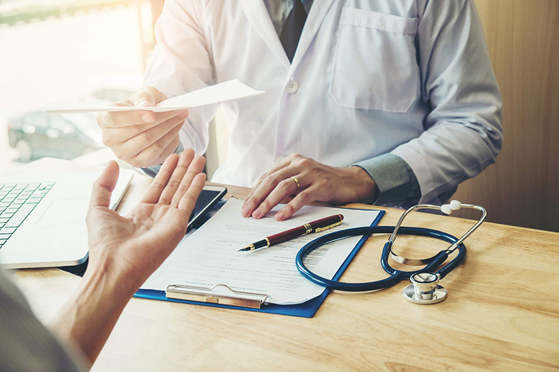 doctor handing lab results to patient