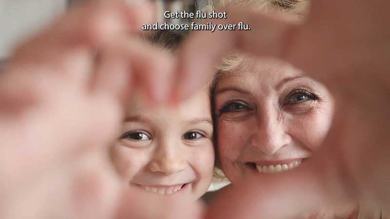 grandmother and child making heart hands in video