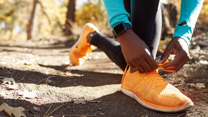 Una corredora afroamericana se amarra los cordones del calzado