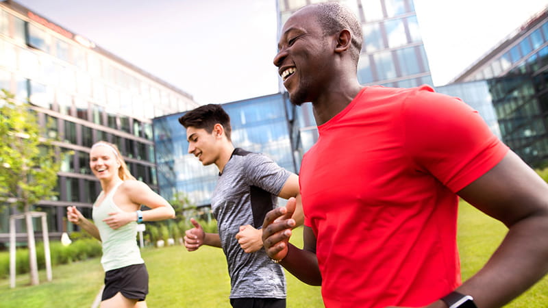 Multi-ethnic friends running or jogging outdoors