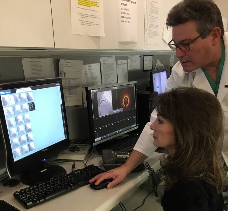 Lucci's cardiologist Dr. Richard Shlofmitz shows her images of the blockages in her arteries, cleared by stents. (Photo courtesy of Jaime Aron)