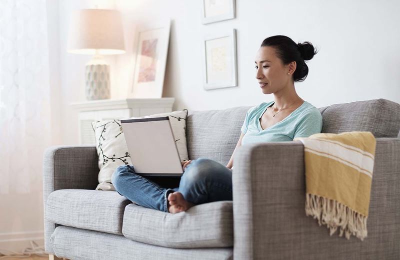 Asian woman reading her laptop