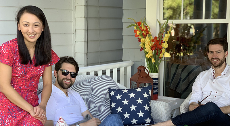 Bonnie's family lounging on the white wicker couch on the porch facing Chautauqua Lake. (Photo courtesy of Bonnie Gwin)