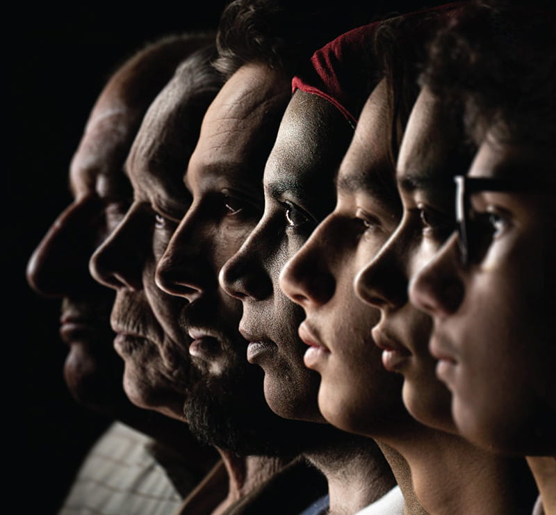 Close up of faces of diverse employees in profile in a row