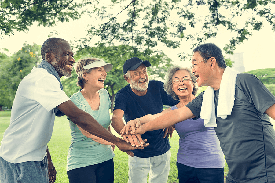 Group of senior retirement friends exercising outdoors