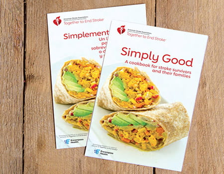 Los libros “Simply Good Cookbook” y “Simplemente bueno: Un libro de recetas” se superponen sobre tablas de madera.
