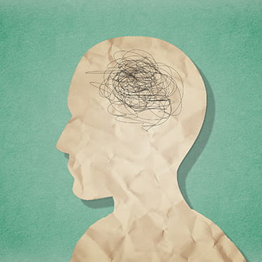 ilustración digital de la silueta de una cabeza de papel sobre un fondo verde con una masa negra garabateada para el cerebro