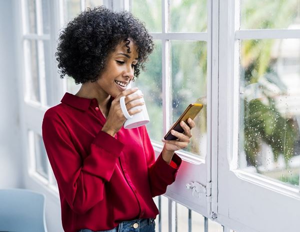 Woman in red uses phone Woman in red uses phone