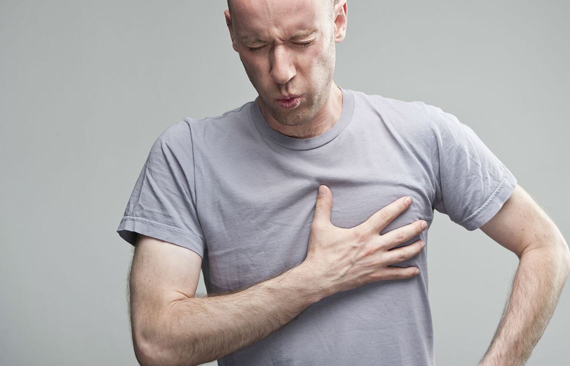 Hombre agarrándose el pecho por dolor