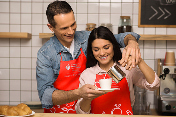 male and female couple modeling A H A branded apron
