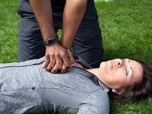 Man giving CPR to woman
