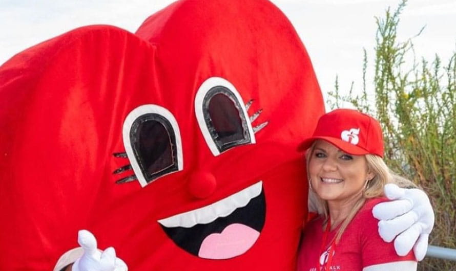 Go Red for Women Class of Survivors Katie Moegenberg with the American Heart Association Heart mascot.