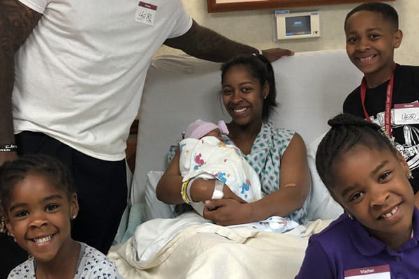 Class of Survivors member Marian and her family in a hospital room