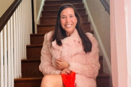 Go Red for Women Class of Survivors member Mary Wiley sitting on the stairs.