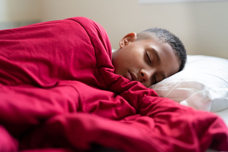 Boy sleeping in his bed