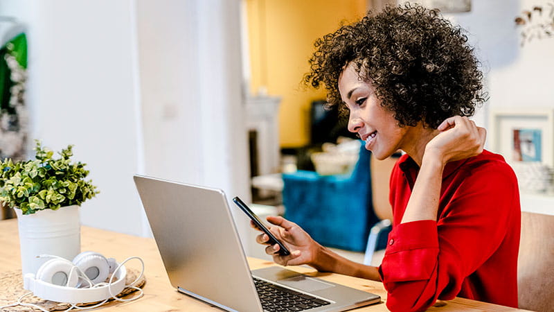 Women working from home at her kitchen table.
