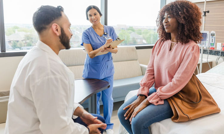 doctor and nurse in exam room with woman patient