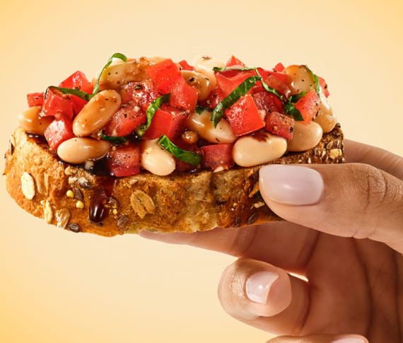 hand holding bruschetta 