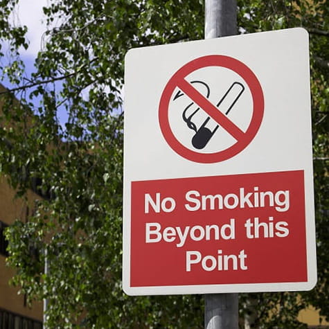 No Smoking beyond this point street sign