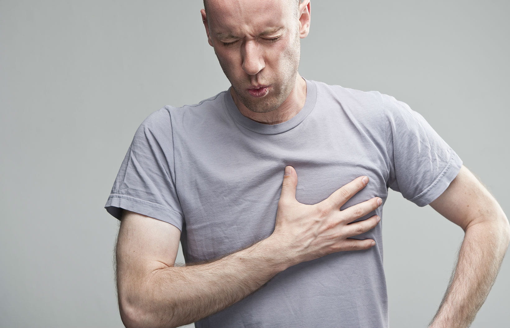 Man clutching his chest in pain
