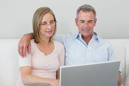 senior couple using laptop senior couple using laptop