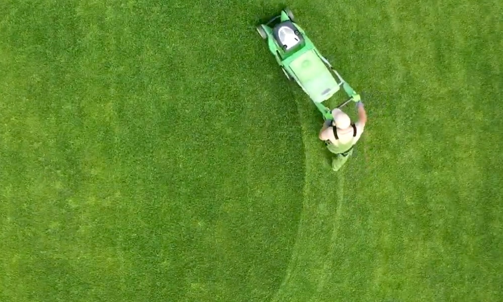 man pushing lawn mower