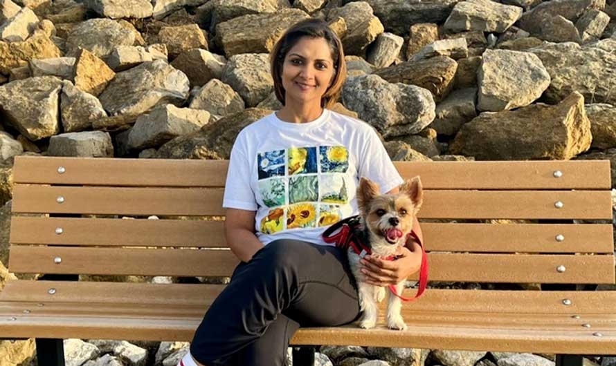 Go Red for Women Class of Survivors member Dipika Aggarwal with her dog on a park bench