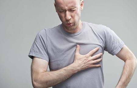 Man clutching his chest in pain